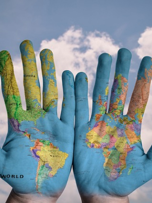 Hands with world map painted on them